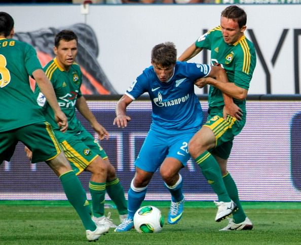 Andrey Arshavin (C) of FC Zenit St. Petersburg vies for the ball with Gheorghe Bucur (L) and Aleksei Kozlov of FC Kuban Krasnodar during the Russian Football League Championship match between FC Zenit St. Petersburg and FC Kuban Krasnodar at the Petrovsky stadium on July 26, 2013 in St. Petersburg, Russia.  (Getty Images)